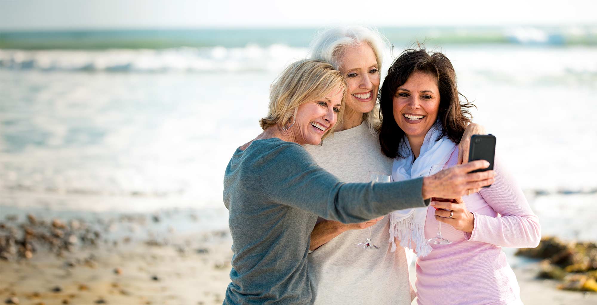 3 women taking a selfie on the beach
